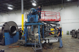Crew of two service workers rebuilding industrial washer